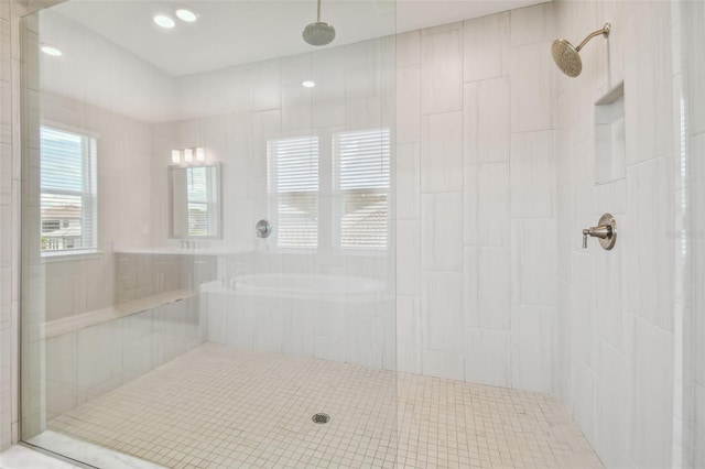 bathroom featuring independent shower and bath