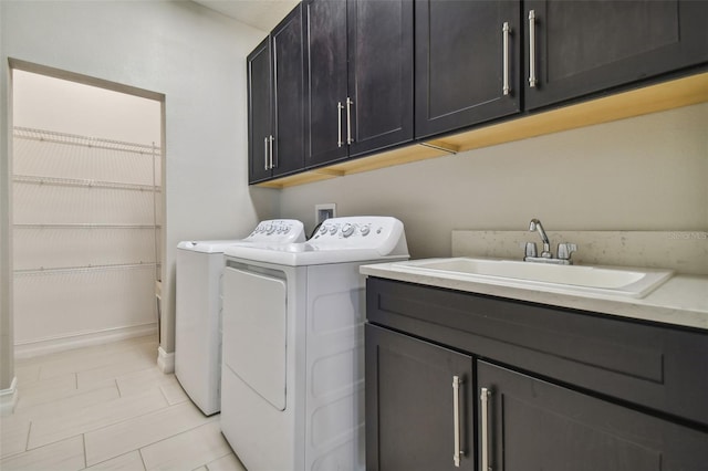 washroom featuring cabinets, washer and clothes dryer, and sink