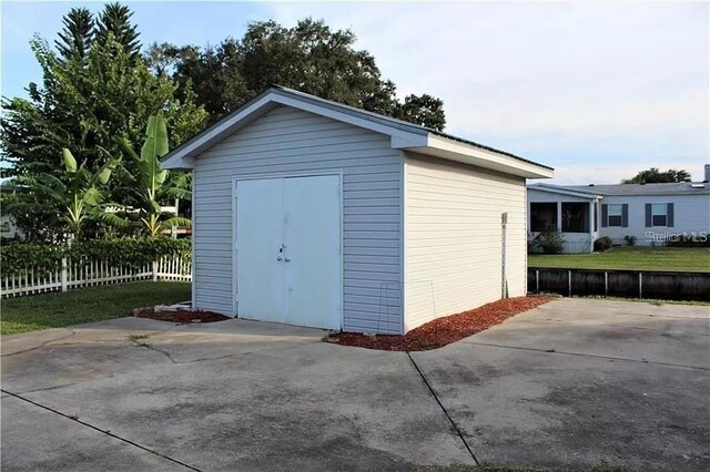 view of outbuilding featuring a yard