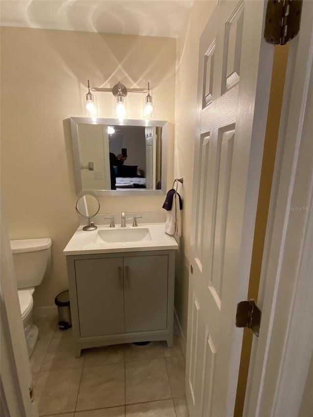 bathroom featuring tile patterned floors, vanity, and toilet