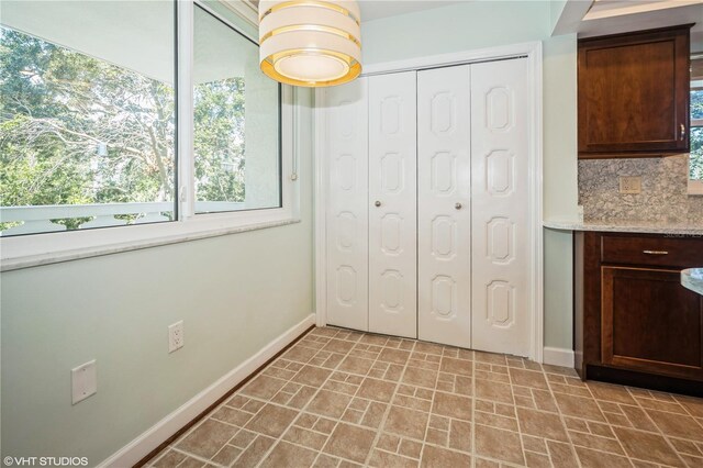 interior space featuring light tile patterned floors and a closet