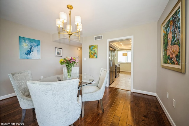 2630 Pearce Dr Unit 404, Clearwater, FL 33764 - dining space featuring dark wood finished floors, baseboards, visible vents, and a chandelier