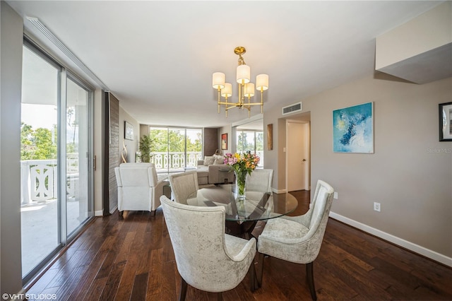 dining room featuring a chandelier, brick wall, and dark hardwood / wood-style floors