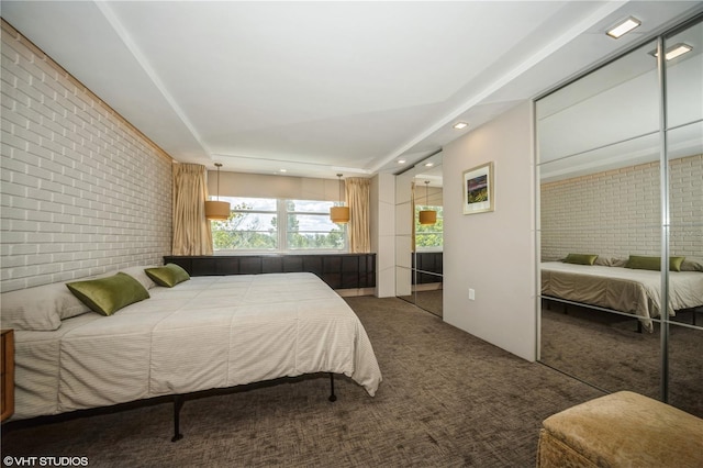 2630 Pearce Dr Unit 404, Clearwater, FL 33764 - carpeted bedroom with recessed lighting and brick wall
