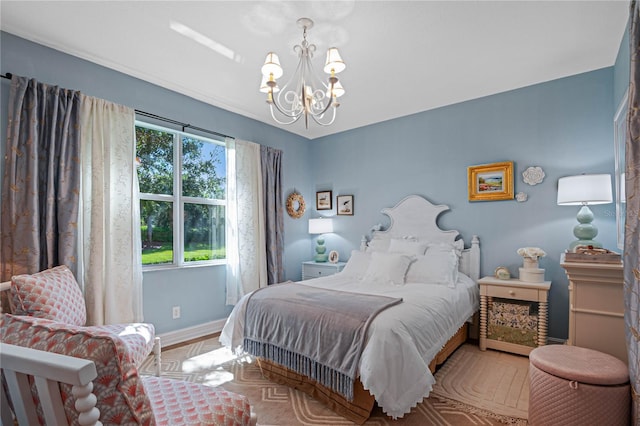 bedroom with a chandelier and light hardwood / wood-style floors