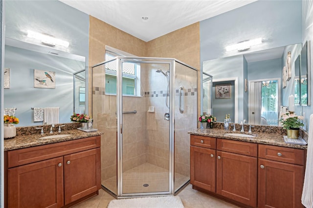 bathroom with vanity, a healthy amount of sunlight, and walk in shower