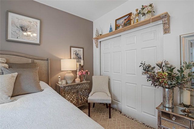 bedroom featuring light carpet and a closet