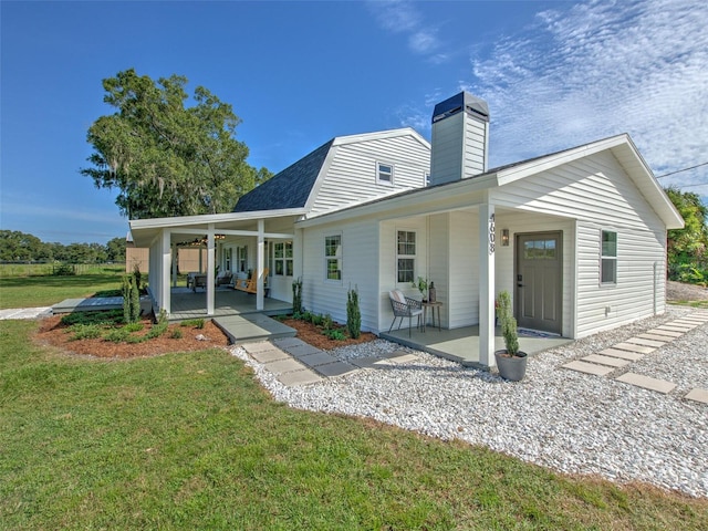 back of property featuring a yard and a patio