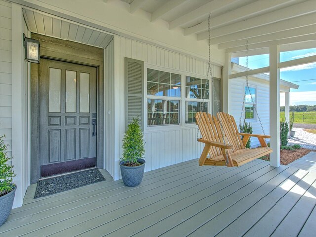 wooden terrace featuring covered porch