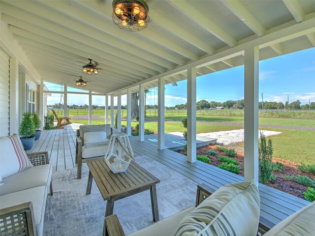 sunroom featuring an outdoor hangout area and beam ceiling