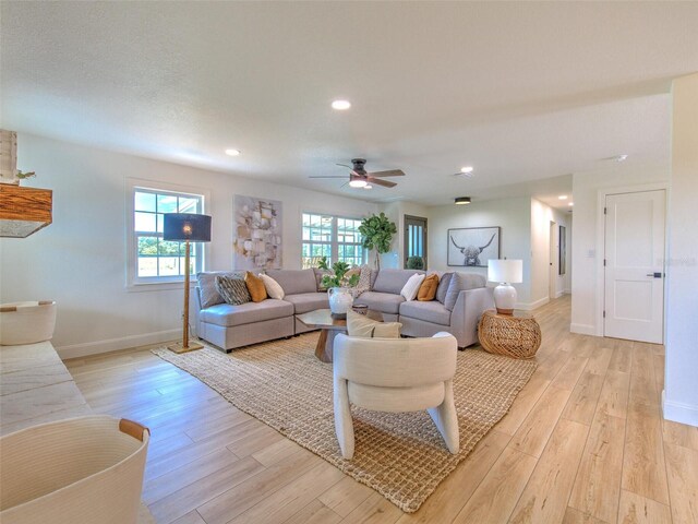 living room with recessed lighting, baseboards, light wood finished floors, and ceiling fan