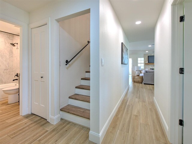 interior space with baseboards, wood finished floors, and recessed lighting