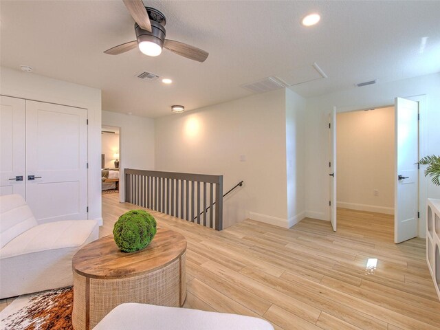 living room featuring ceiling fan and light wood-type flooring