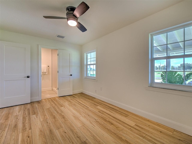 unfurnished bedroom with multiple windows, ceiling fan, and light hardwood / wood-style flooring