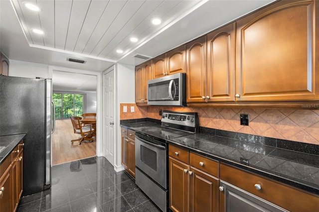 kitchen featuring backsplash, dark wood-type flooring, and stainless steel appliances