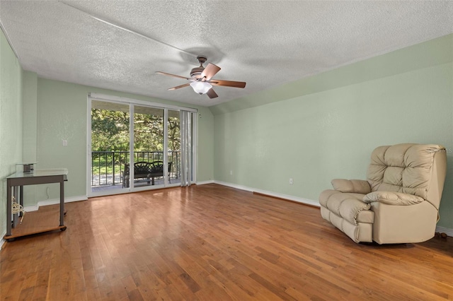 sitting room with ceiling fan, a textured ceiling, and hardwood / wood-style flooring