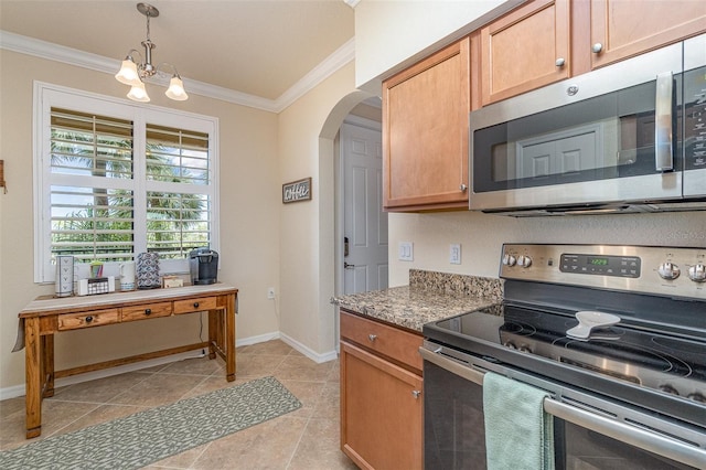 kitchen featuring pendant lighting, stainless steel appliances, arched walkways, crown molding, and baseboards