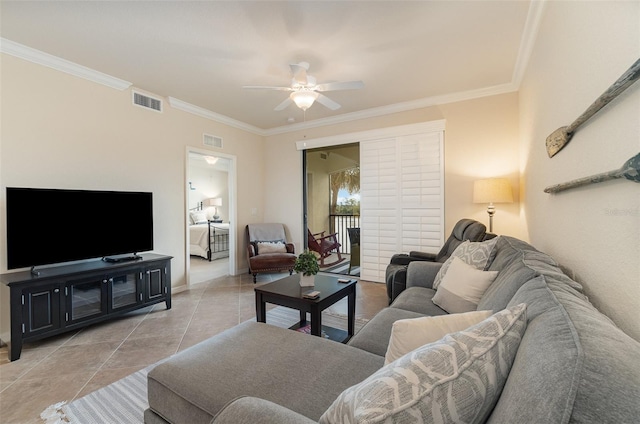 tiled living area featuring visible vents, baseboards, crown molding, and ceiling fan