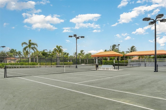 view of tennis court featuring fence