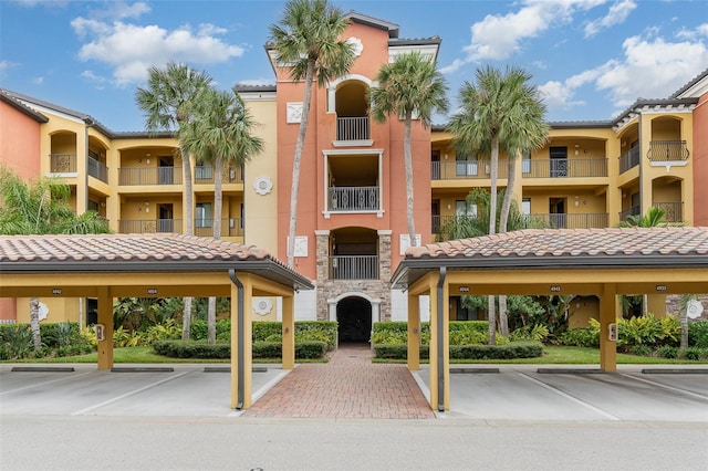 view of property with covered and uncovered parking