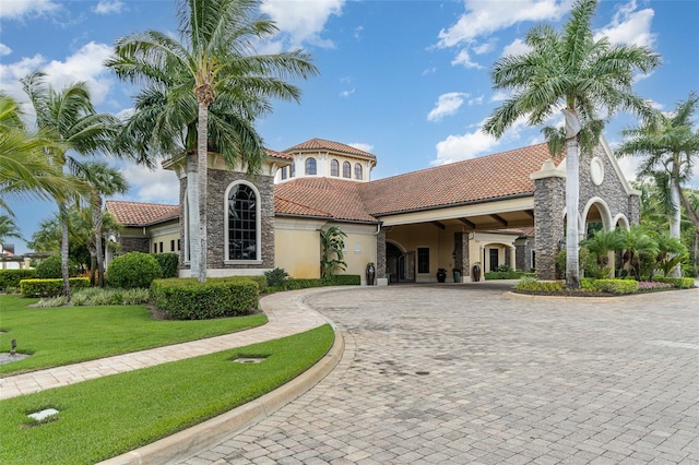 view of building exterior with decorative driveway