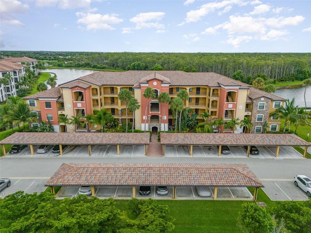 view of property featuring a water view and uncovered parking