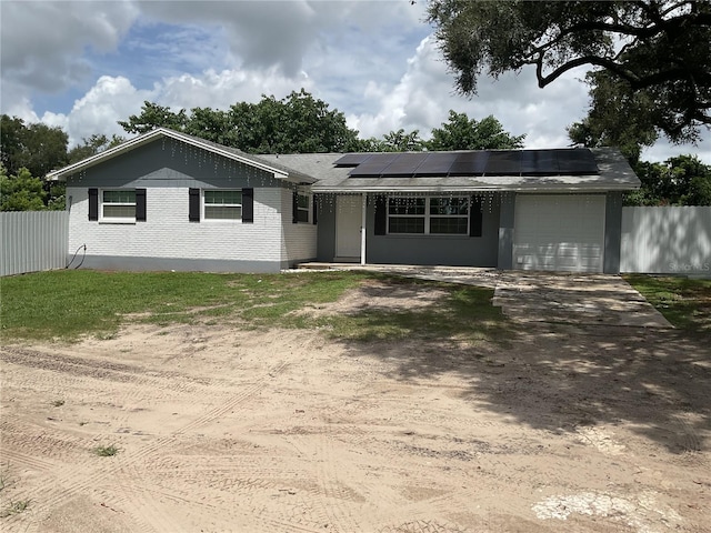 ranch-style house featuring solar panels