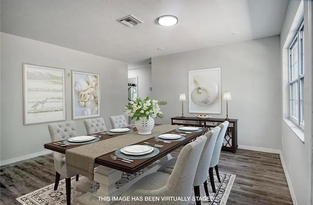 dining area with a wealth of natural light and dark hardwood / wood-style floors