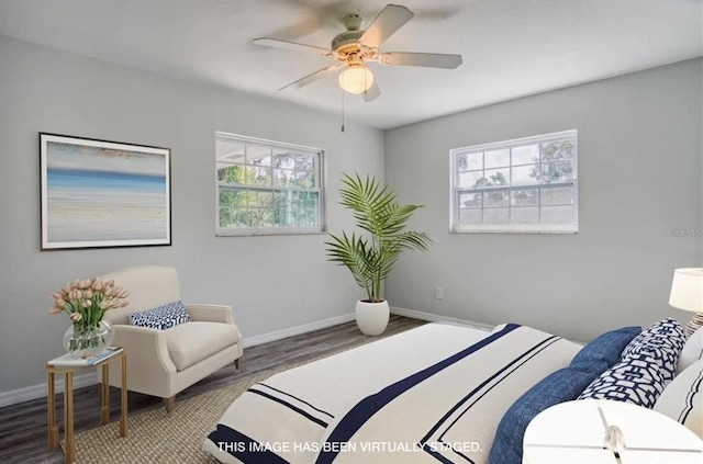 bedroom with multiple windows, wood-type flooring, and ceiling fan