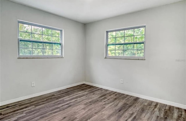 empty room with dark wood-type flooring