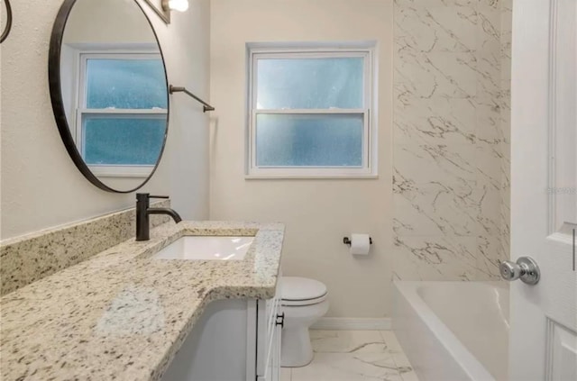 bathroom featuring vanity, toilet, and a tub