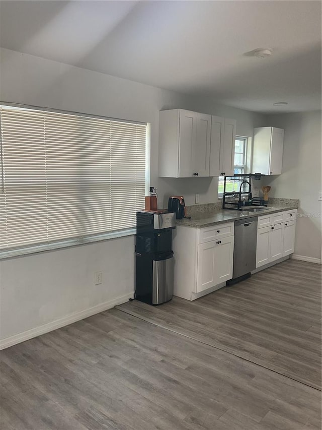 kitchen featuring white cabinets, wood-type flooring, sink, and stainless steel dishwasher