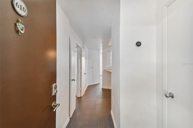 hall with dark hardwood / wood-style floors