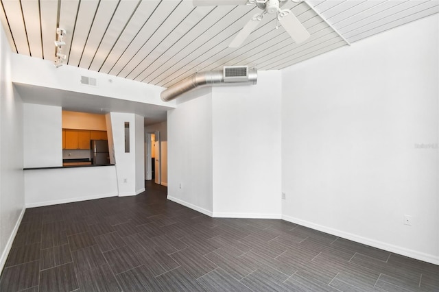 empty room featuring wood ceiling, ceiling fan, and track lighting