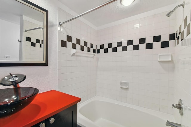 bathroom featuring vanity, shower / washtub combination, a textured ceiling, and a textured wall