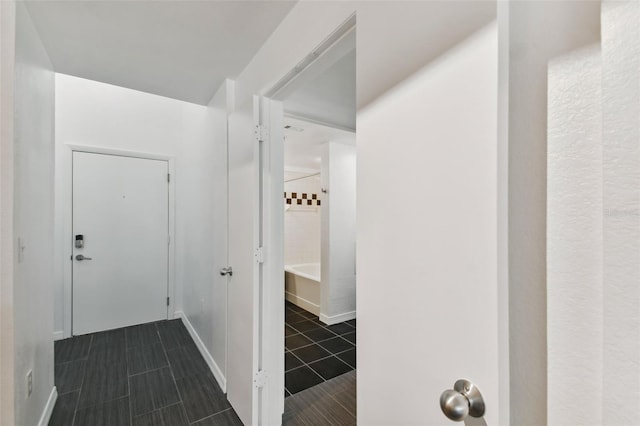 corridor with dark tile patterned floors