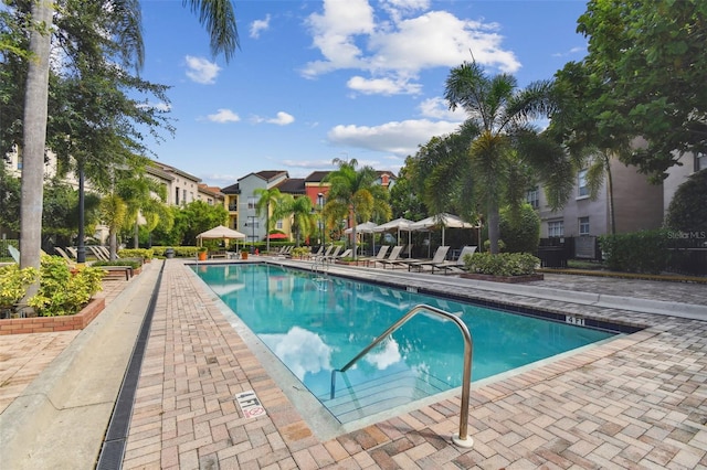 community pool featuring a residential view and a patio