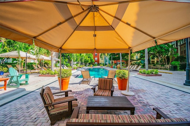 view of patio featuring a community pool and a gazebo