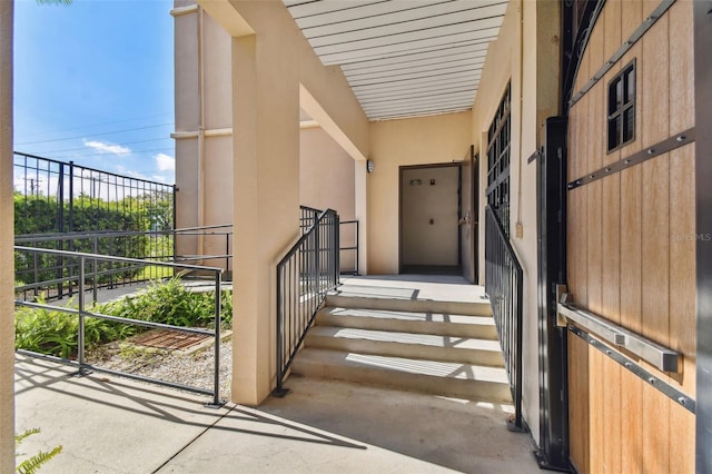 doorway to property featuring stucco siding