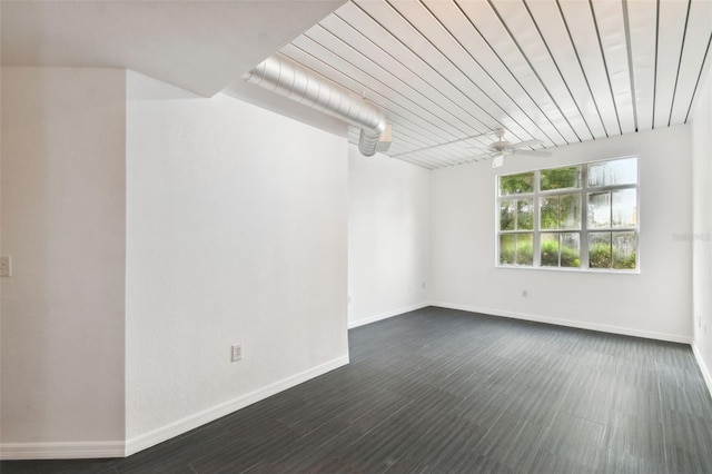 spare room featuring dark wood-type flooring and ceiling fan