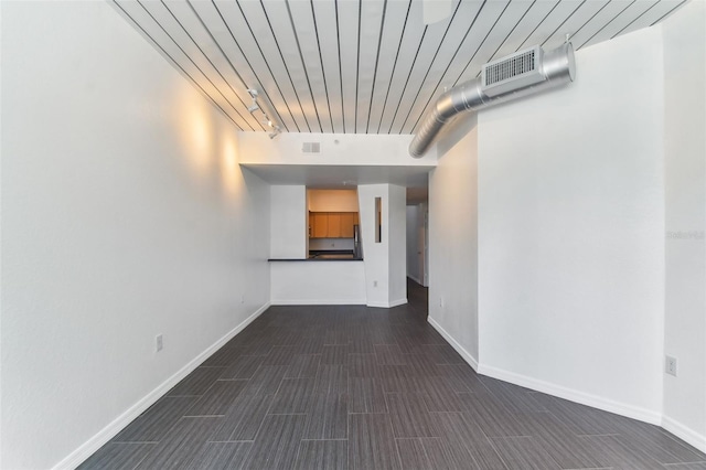 hallway with visible vents and baseboards