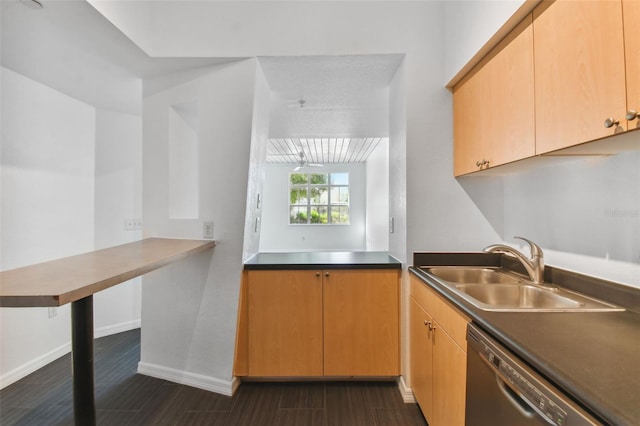 kitchen featuring dark tile patterned floors, dishwasher, kitchen peninsula, sink, and light brown cabinets