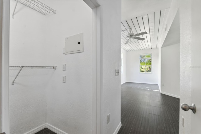 hallway with dark wood-style floors and baseboards