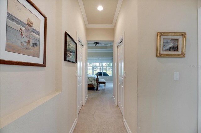 corridor with light carpet and crown molding