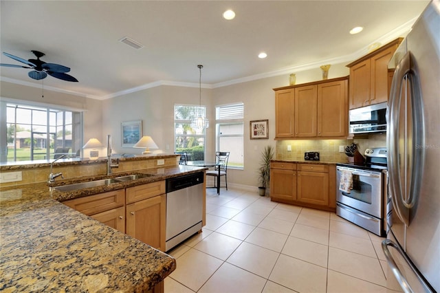 kitchen featuring stainless steel appliances, tasteful backsplash, light stone counters, decorative light fixtures, and ornamental molding