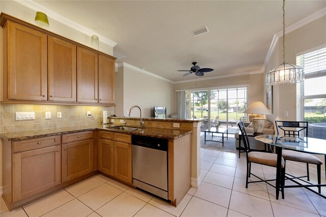 kitchen featuring dishwasher, light tile patterned floors, a wealth of natural light, and sink