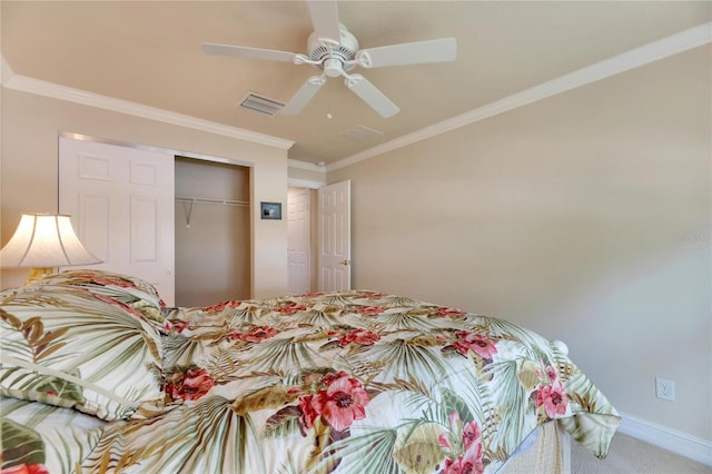 carpeted bedroom with ceiling fan, a closet, and crown molding