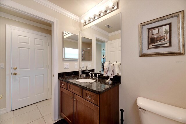 bathroom with tile patterned flooring, toilet, vanity, and ornamental molding