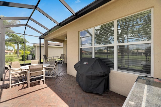 view of patio featuring a grill and a lanai