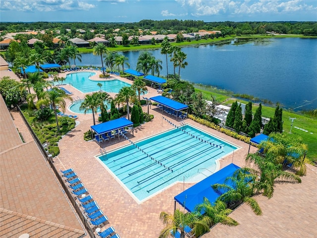 view of pool with a patio and a water view